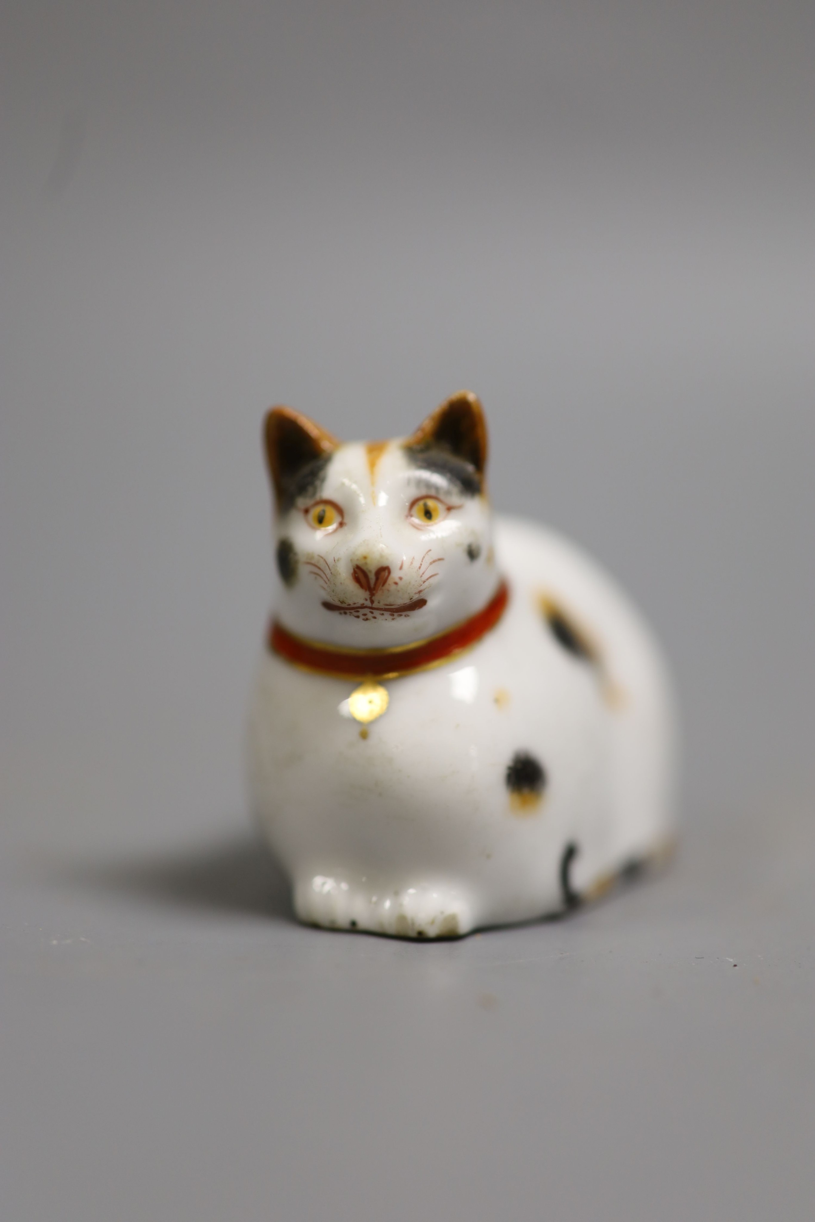 A rare Chamberlain Worcester porcelain model of a recumbent cat, c.1820-40, 6cm